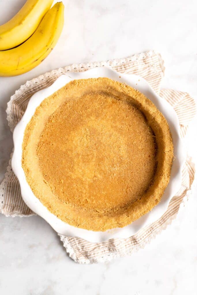 A pie plate filled with graham cracker crust