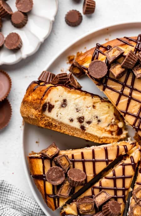A close up of peanut butter cup cheesecake with a slice turned up
