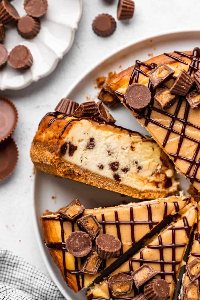 A close up of peanut butter cup cheesecake with a slice turned up