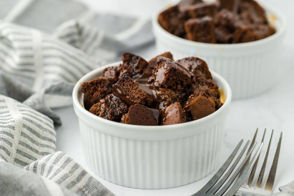 Ramekins of gingerbread bread pudding with forks on the side.