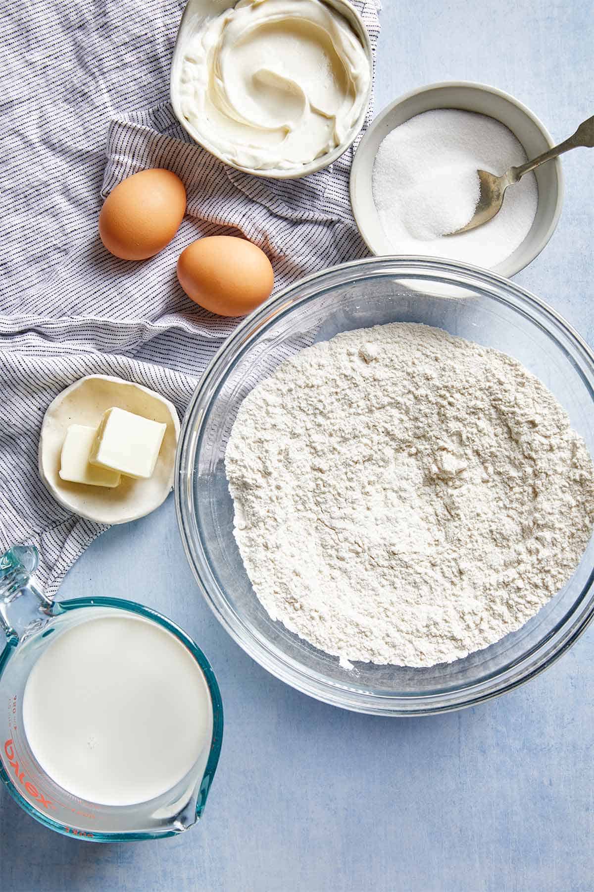 Ingredients to make classic pancakes on the table before mixing together.