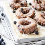 Tray of Blueberry Glazed Doughnuts on parchment paper