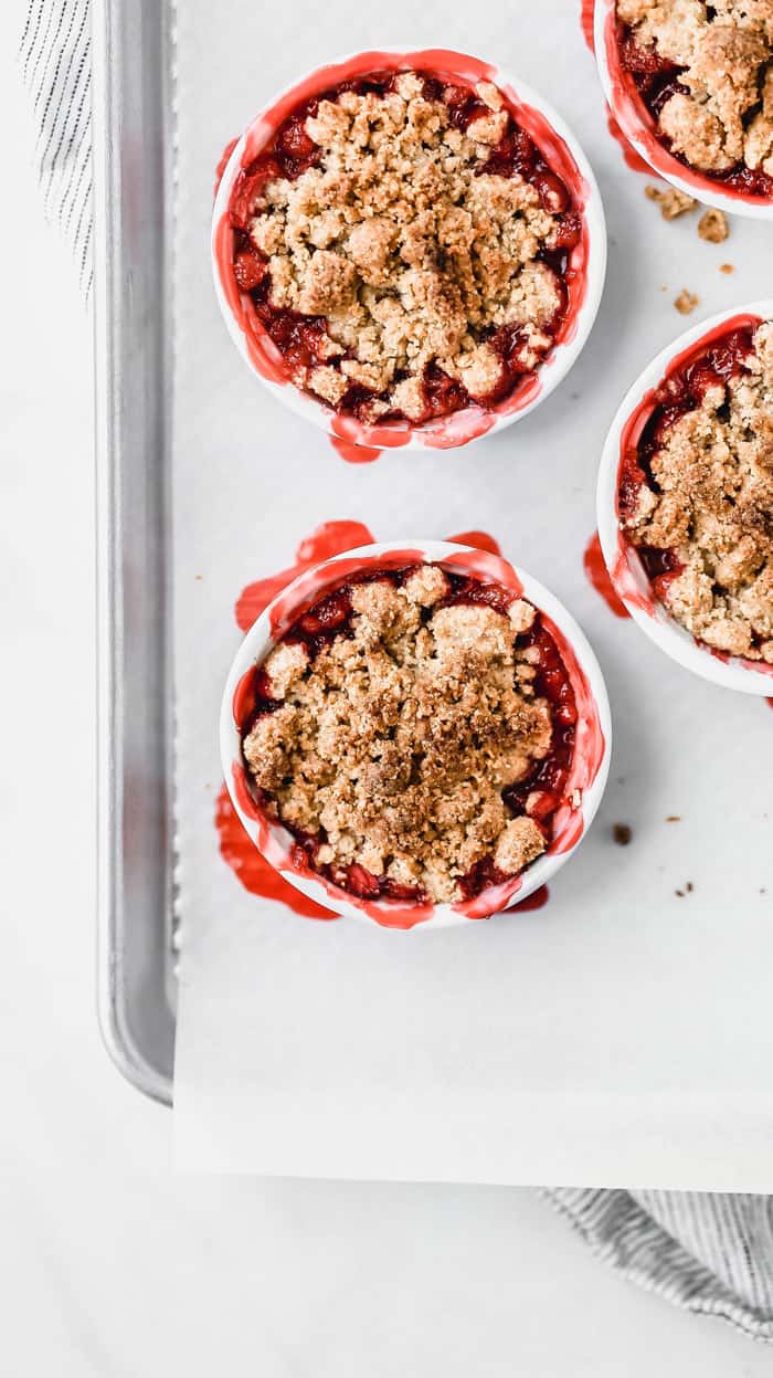 Overhead shot of individual Strawberry Crumbles Recipe out of the oven on baking sheet