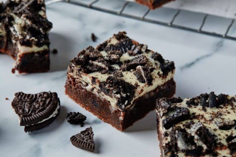 Oreo cookie bars on the counter in front of a cooling rack.