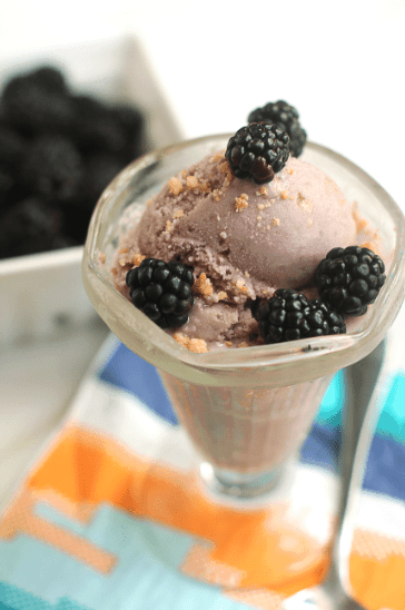 Blackberry Crumble Ice Cream contained in a glass and topped with fresh blackberries.