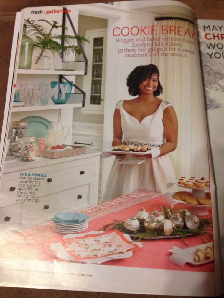 Better Homes & Gardens article featuring Jocelyn Delk Adams who is wearing a white sleeveless dress and holding a white tray of appetizers