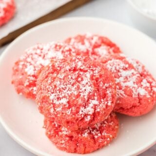 Raspberry butter cookies on a white plate.