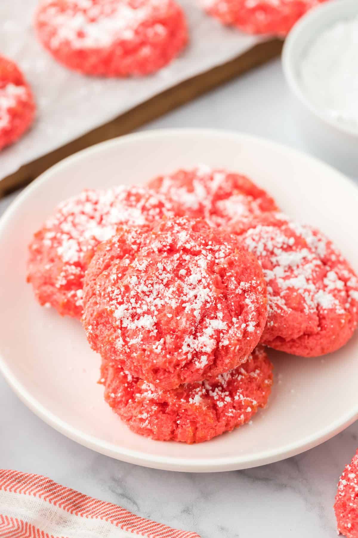 Raspberry butter cookies on a white plate.