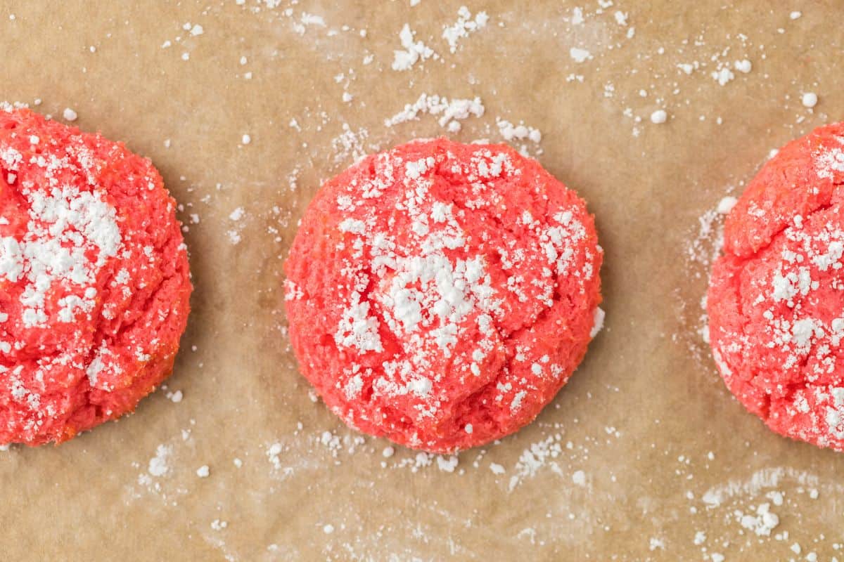 Raspberry gooey butter cookies on a piece of parchment.