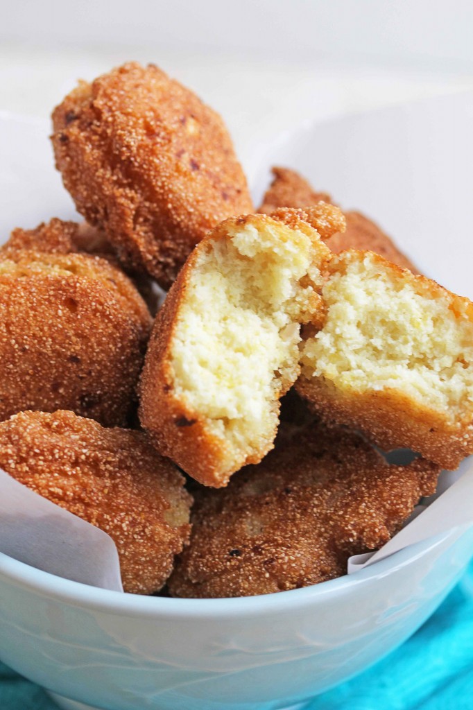 A hush puppy broken apart with delicious tender inside on stack