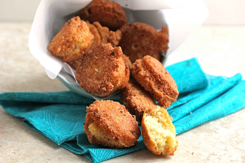 Fried hush puppies spilling out of bowl