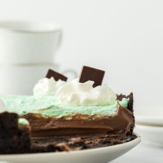 Mint chocolate cream pie with a slice missing showing the inside of the pie.