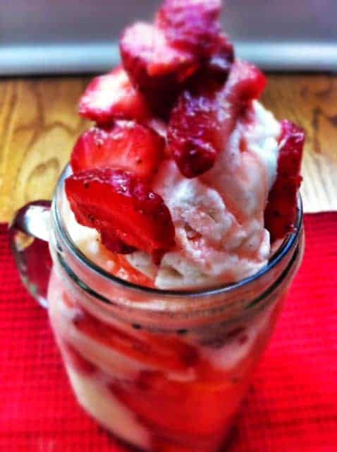A strawberry ice cream float contained in a glass mug
