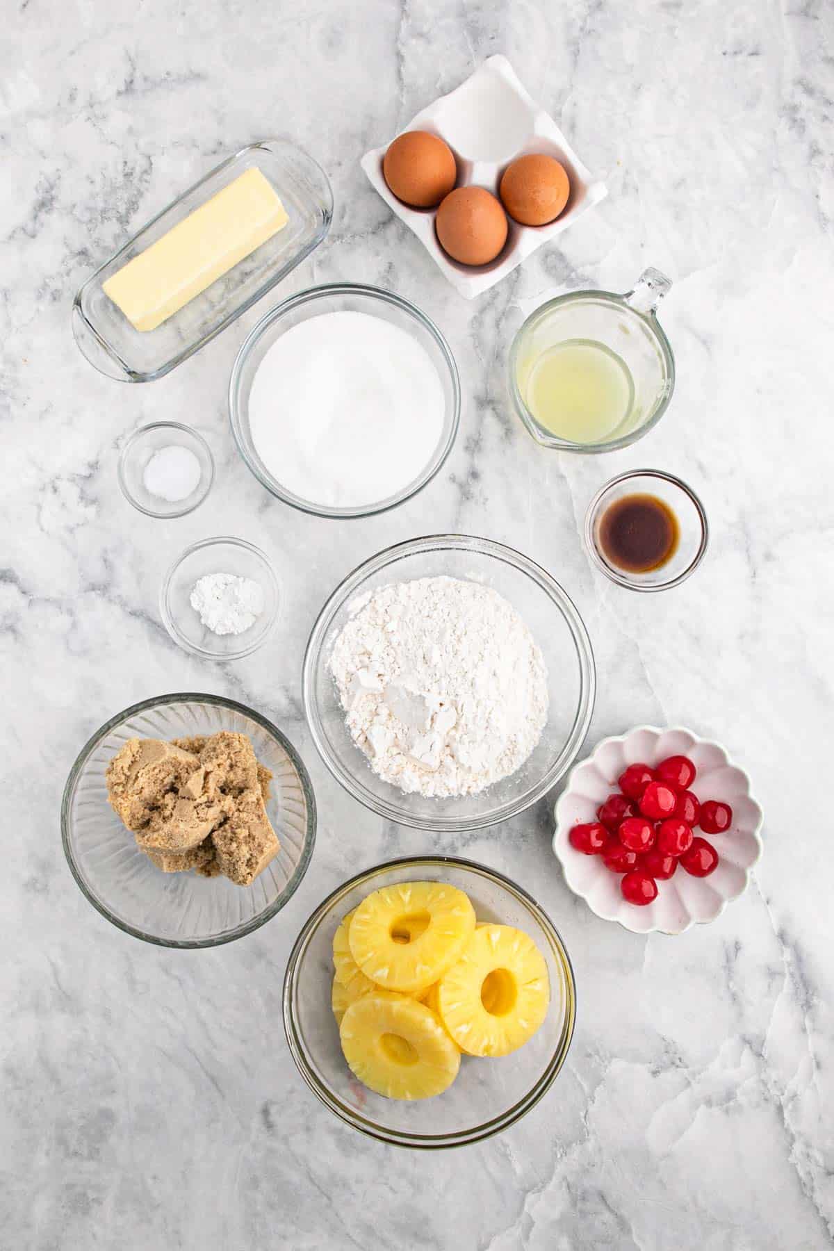 Ingredients to make pineapple upside down cake on the table in bowls.