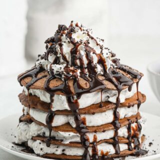Oreo Pancakes in a stack of white plate on white background