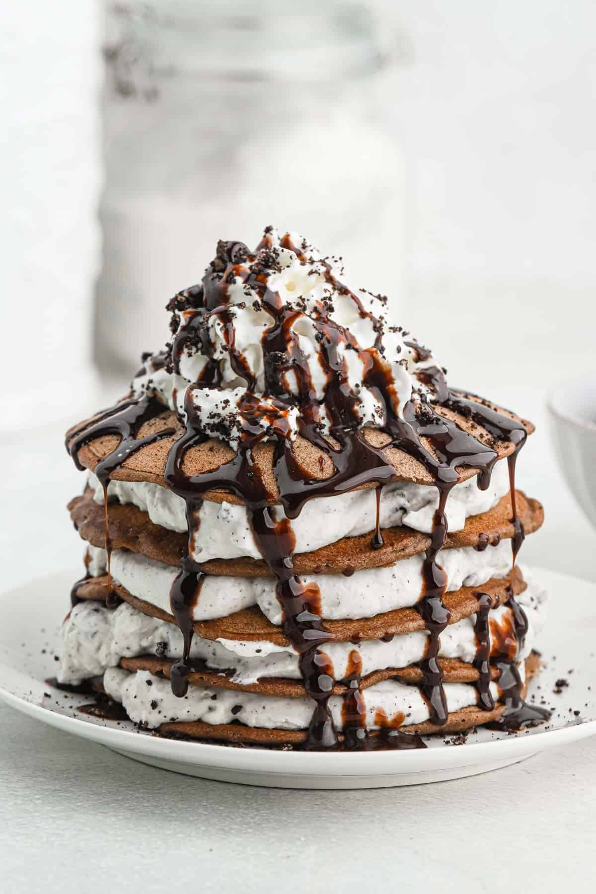 Oreo Pancakes in a stack of white plate on white background