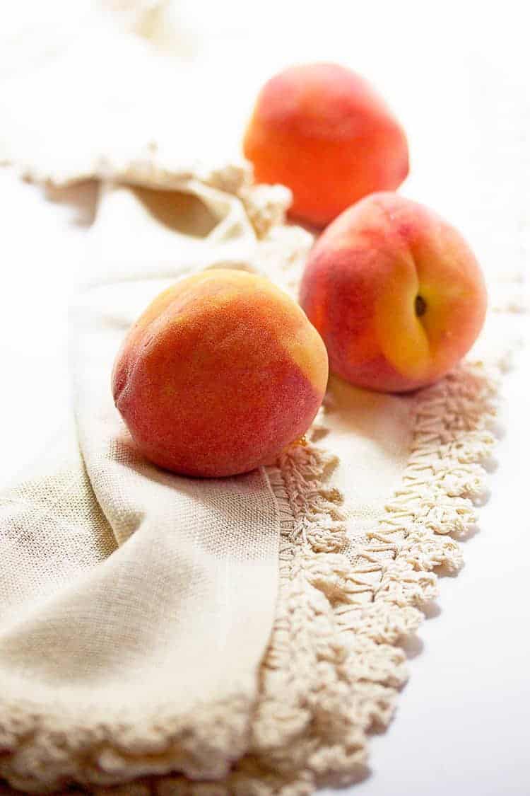 Fresh summer ripe peaches against white background ready to make pie