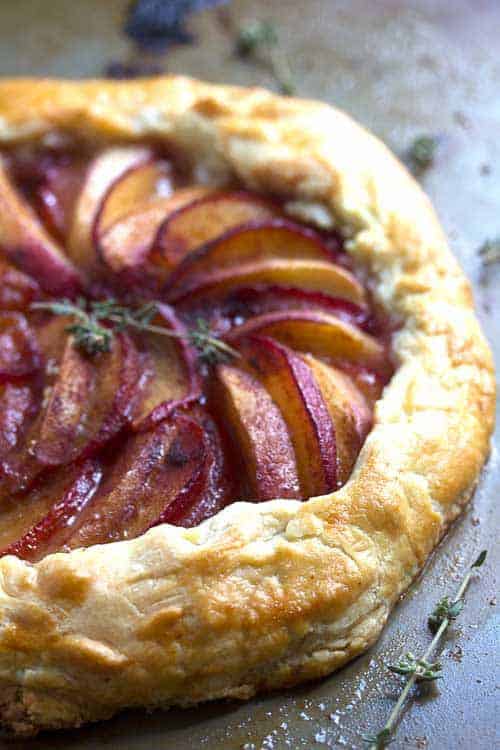 Close up of a plum galette sitting a wooden surface