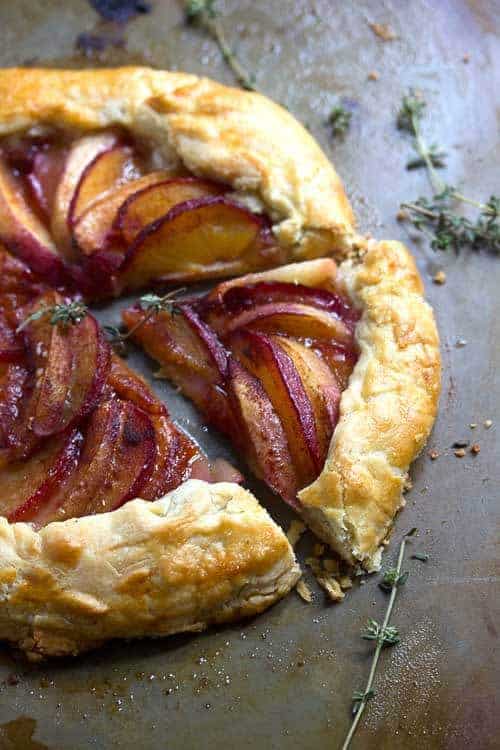 Close up of a plum necatrine galette with a slice cut out of it 