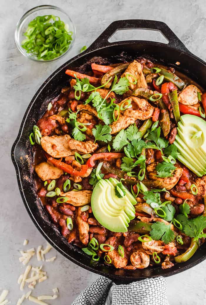 Close up of an overhead shot of a black cast iron skillet full of fajita chili 