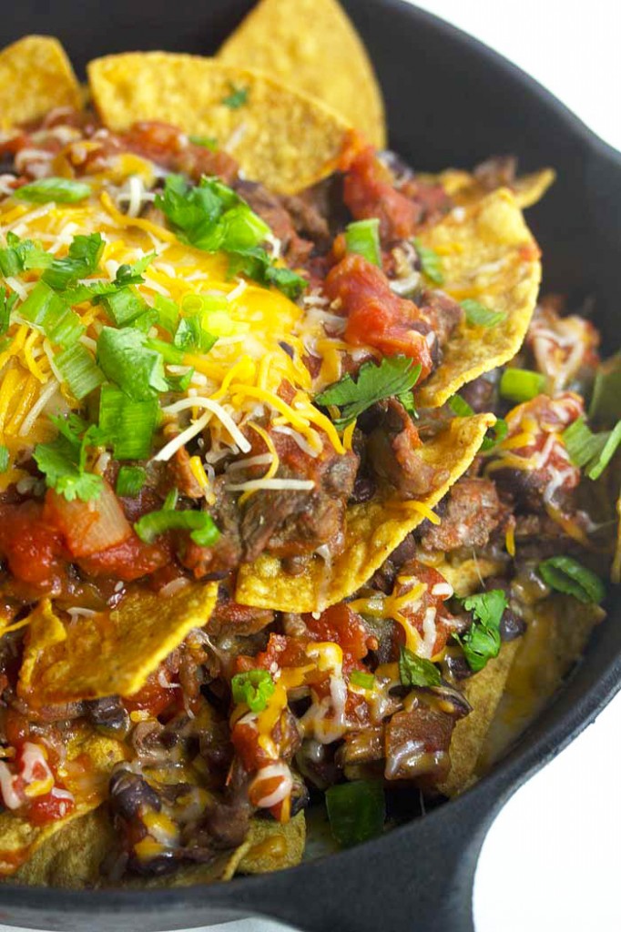Delicious steak nachos recipe covered in cheese and salsa ready to serve for the Super Bowl