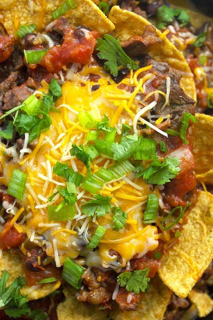 A close up of steak nachos with melted cheese