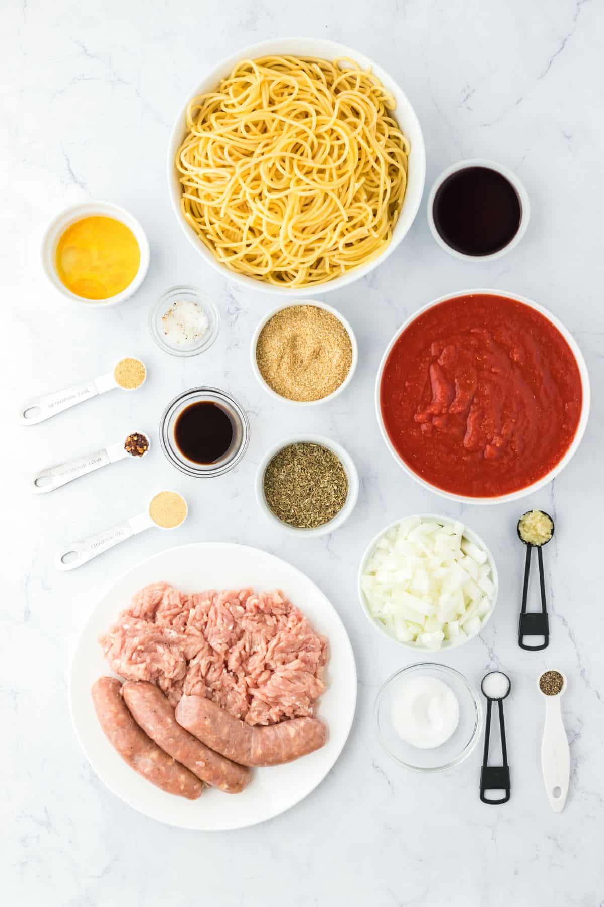 Ingredients to make homemade spaghetti and meatballs on the table.