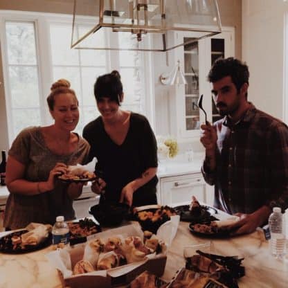 Three food stylists for the photo shoot pose for a photo