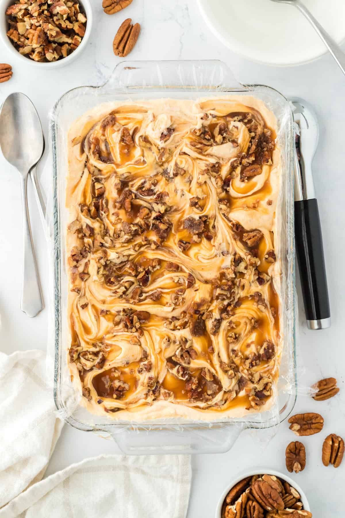 Caramel pecan swirled sweet potato pie ice cream on a white countertop ready to serve