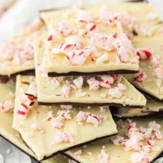 Peppermint bark pieces stacked up on a plate.