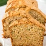 Slices of zucchini bread cake lined up slightly off center on the table.