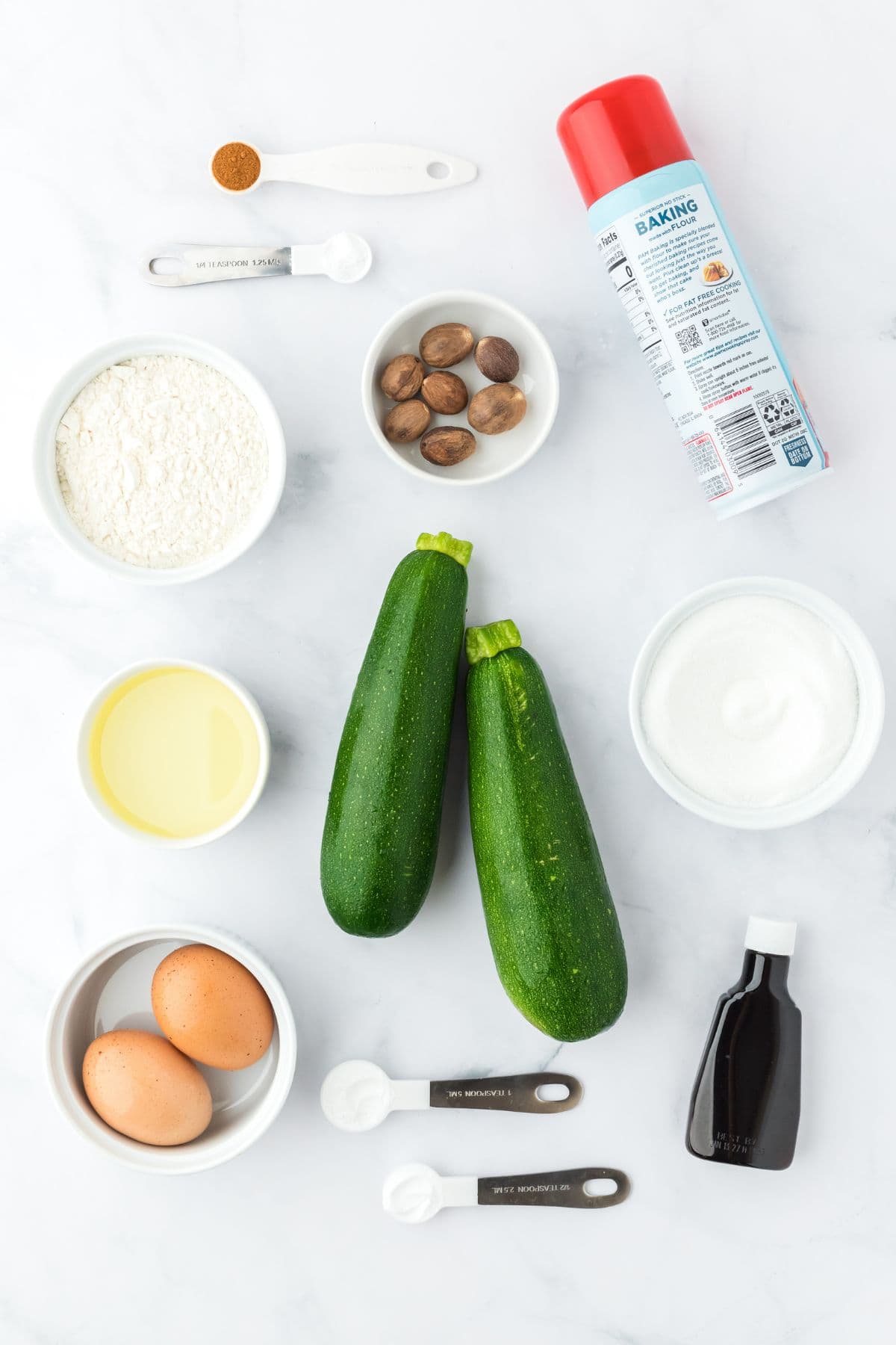 Ingredients to make zucchini bread on the table before mixing together.