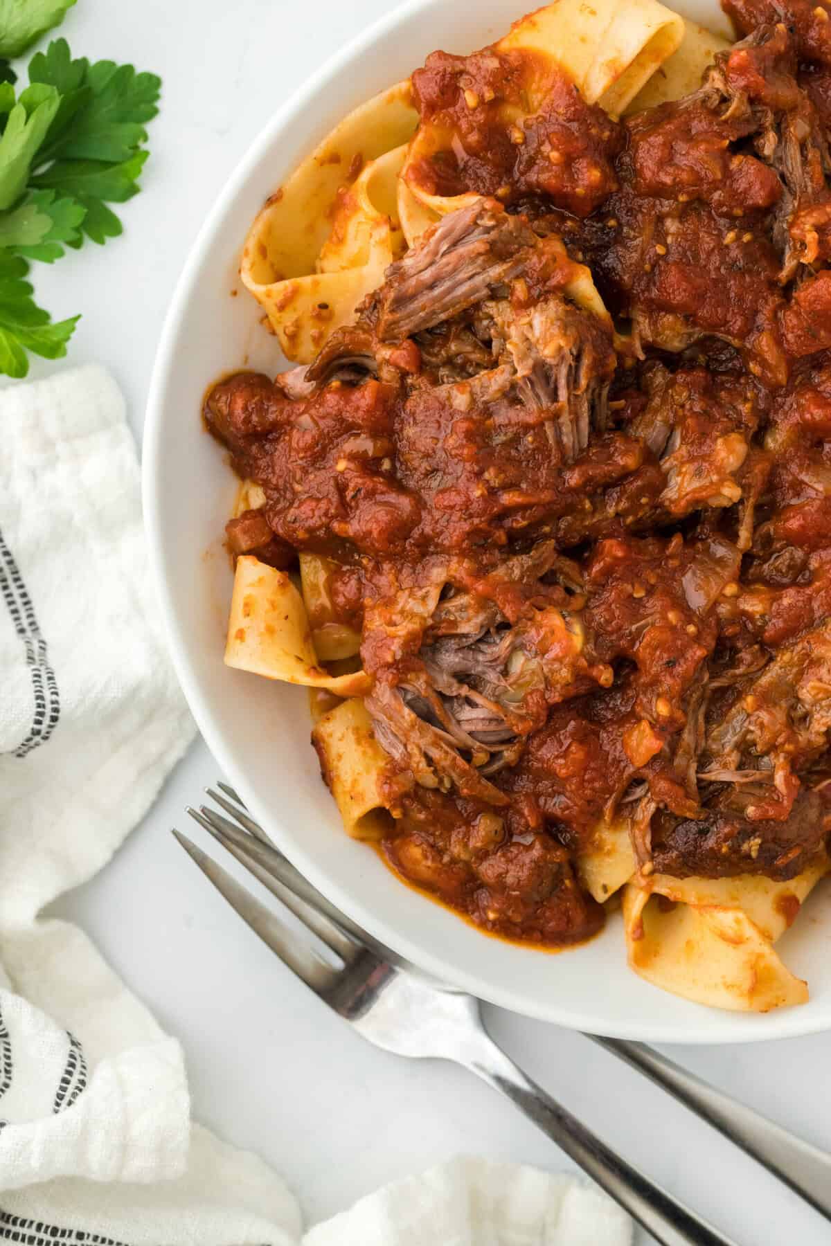 Ragu spaghetti sauce on pasta on white plate ready to serve