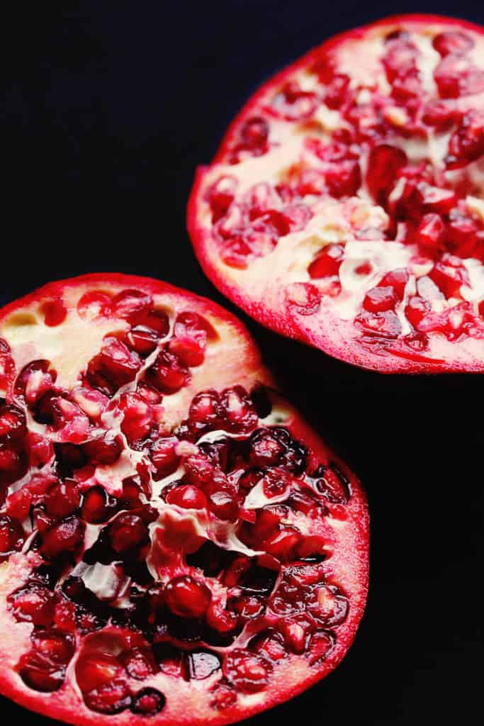 Overhead shot of two halves of a fresh pomegranate