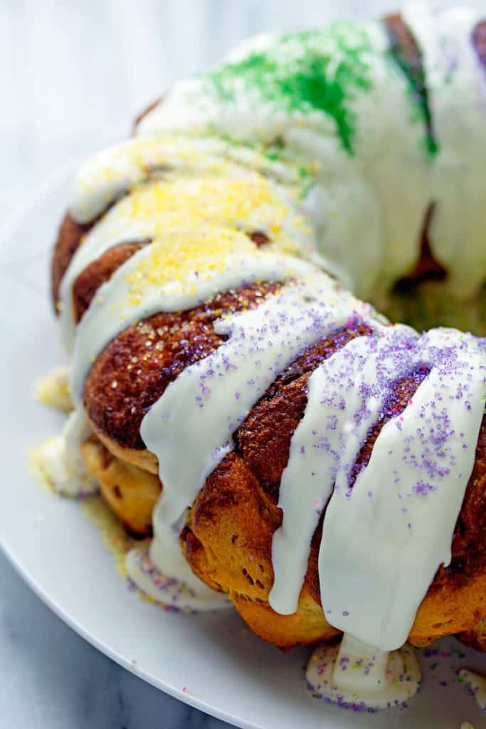 Mardi Gras King Cake topped cream cheese icing and sprinkles