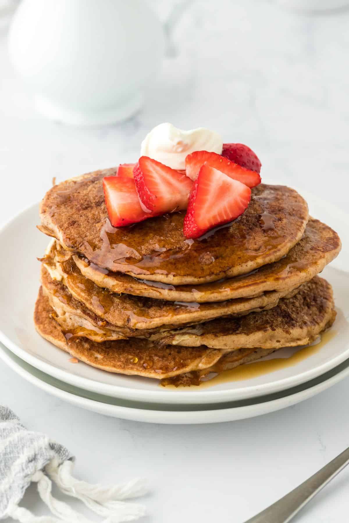 Delicious stack of french toast pancakes recipe with syrup and raspberries ready to serve