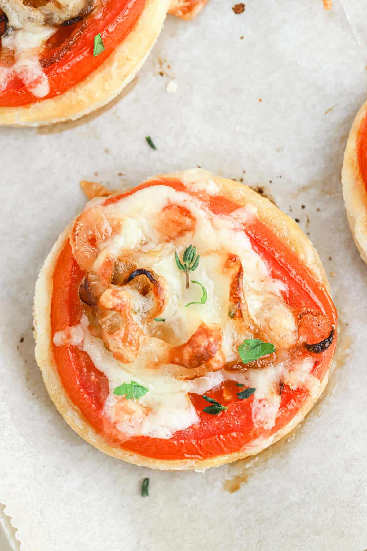 Overhead view of tomato tart on a baking sheet.