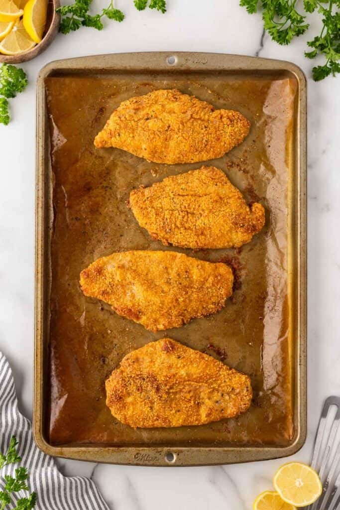 Completed oven fried fish on a baking sheet