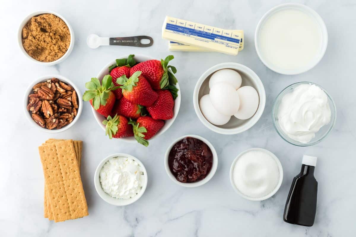 Ingredients to make a strawberry custard pie on the table.
