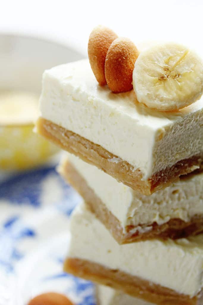 Banana Pudding Cheesecake Bars Recipe Blondies close up stack with nilla waffers and banana slices