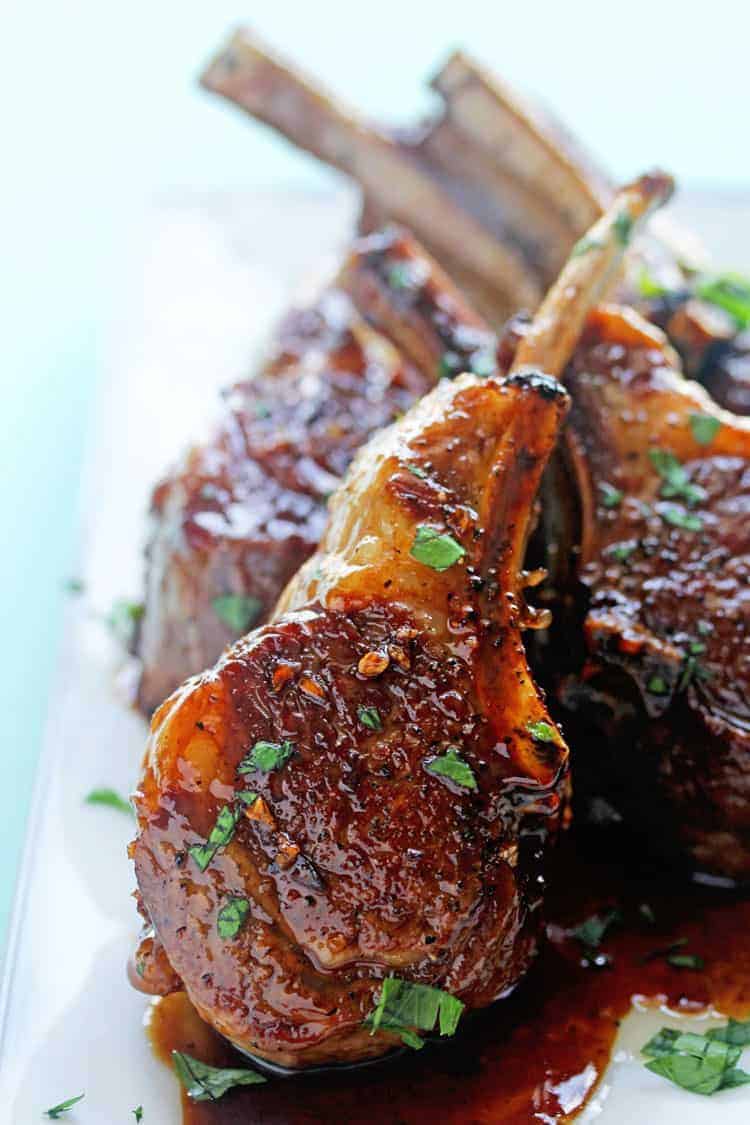 Learn how to cook best lamb chops with this close up of the best lamb chop recipe pictured here resting on a white plate. 