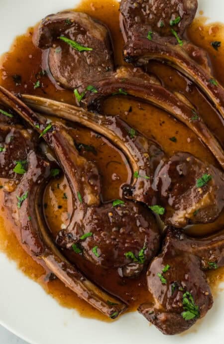 Perfect lamb chops recipe on a white plate close up