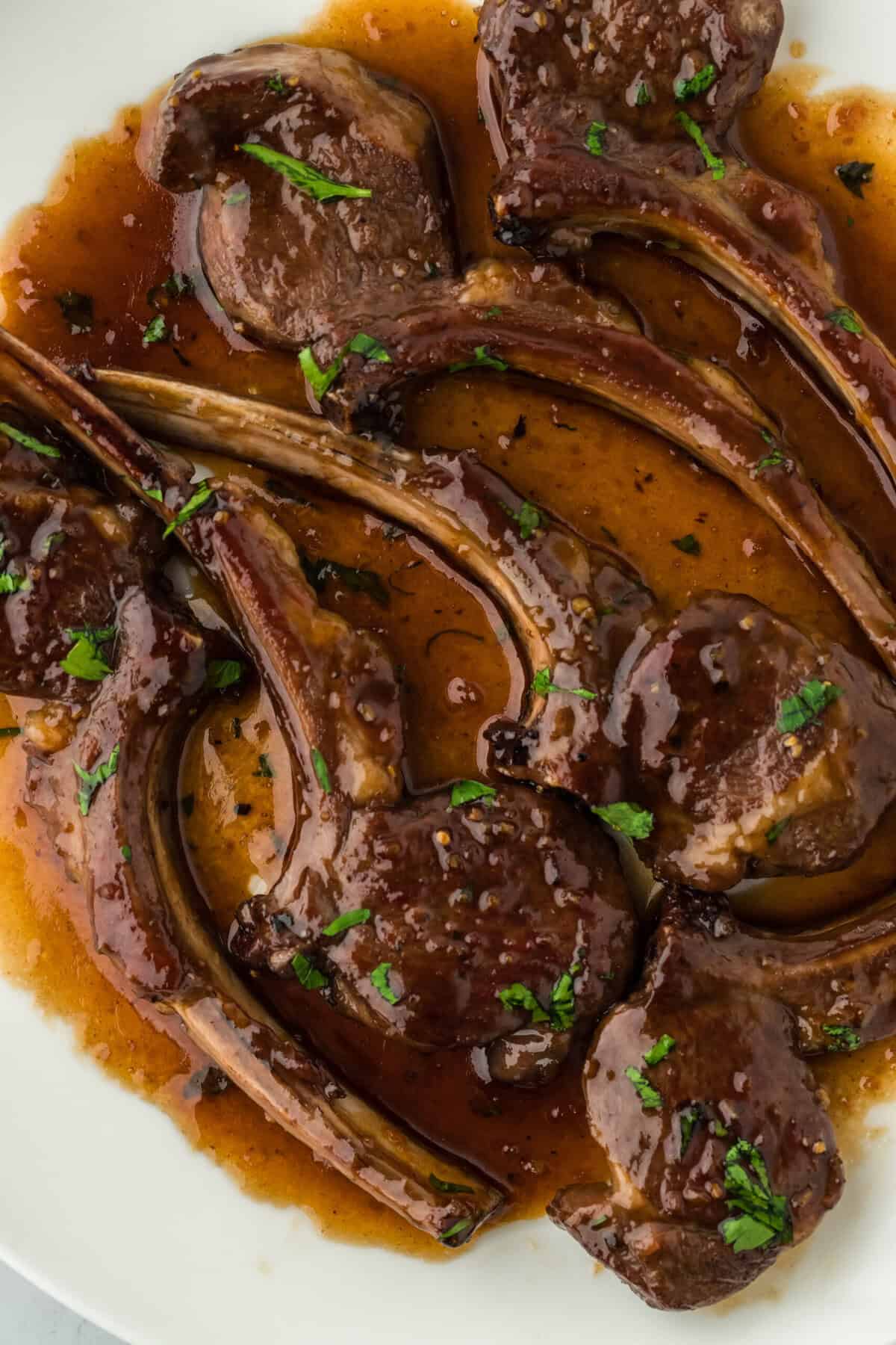 Perfect lamb chops recipe on a white plate close up