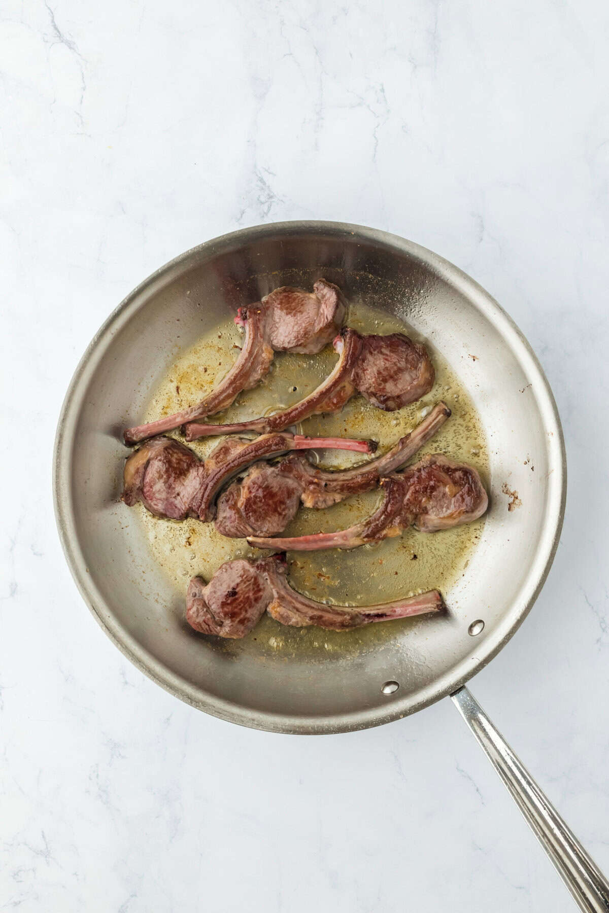 Lamb loin chops seared in a skillet