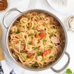 Overhead view of Cajun shrimp pasta in a stainless steel pot