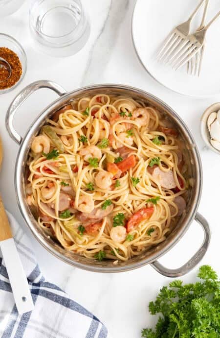 Overhead view of Cajun shrimp pasta in a stainless steel pot