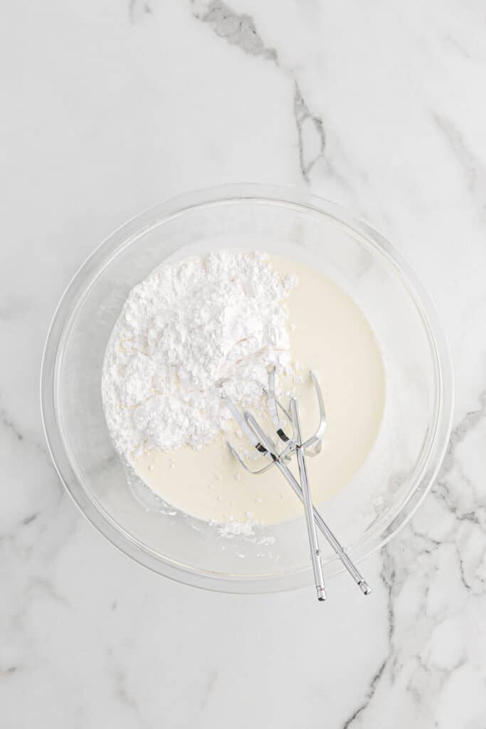 Whipping the sugar into the rest of the whipping cream.