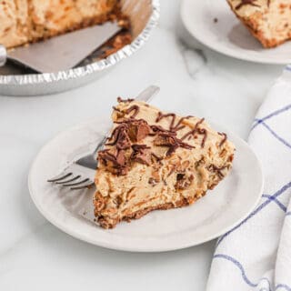A slice of no bake peanut butter pie on a white plate.