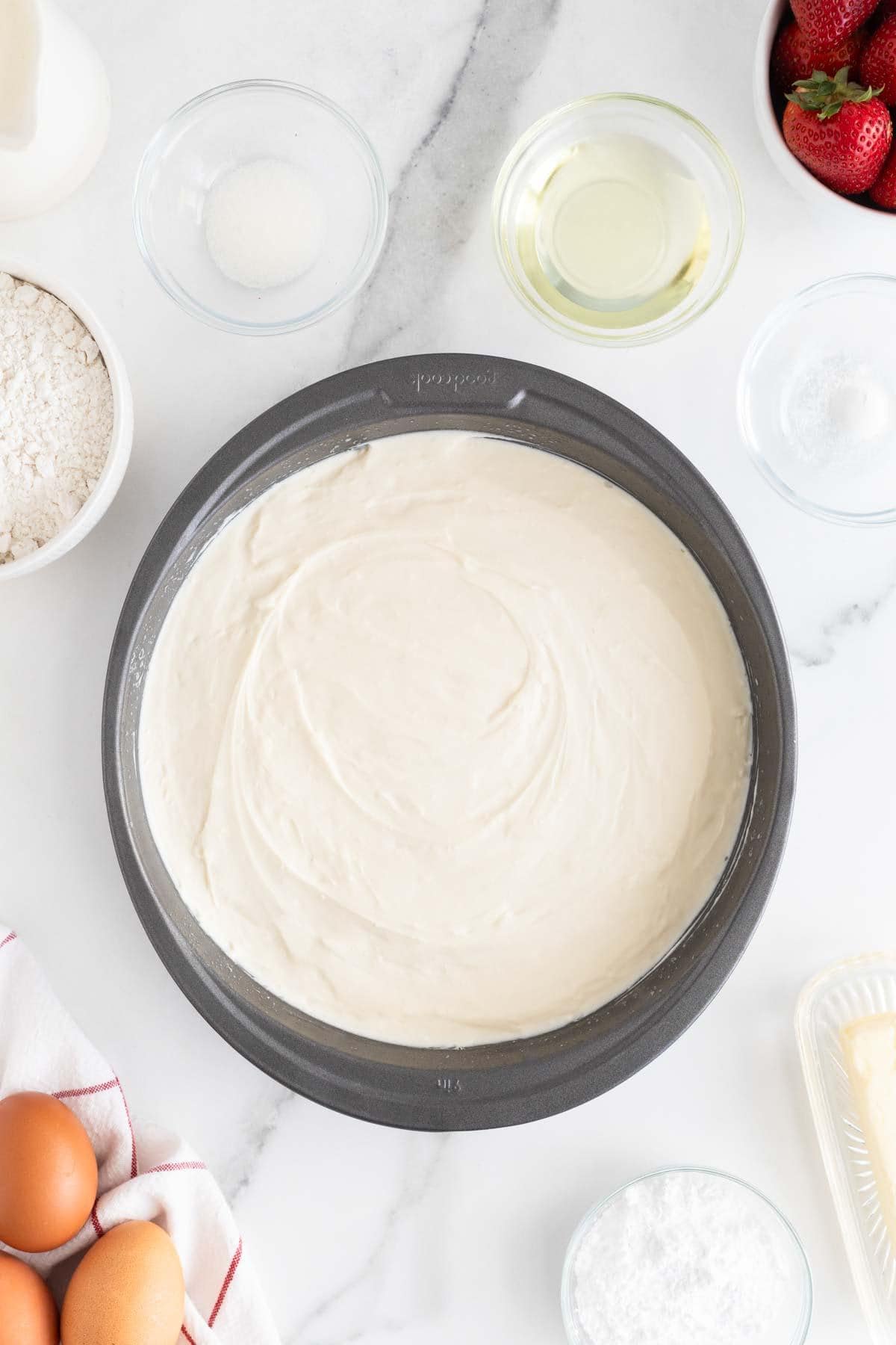 Cheesecake after refrigerating, surrounded by baking ingredients