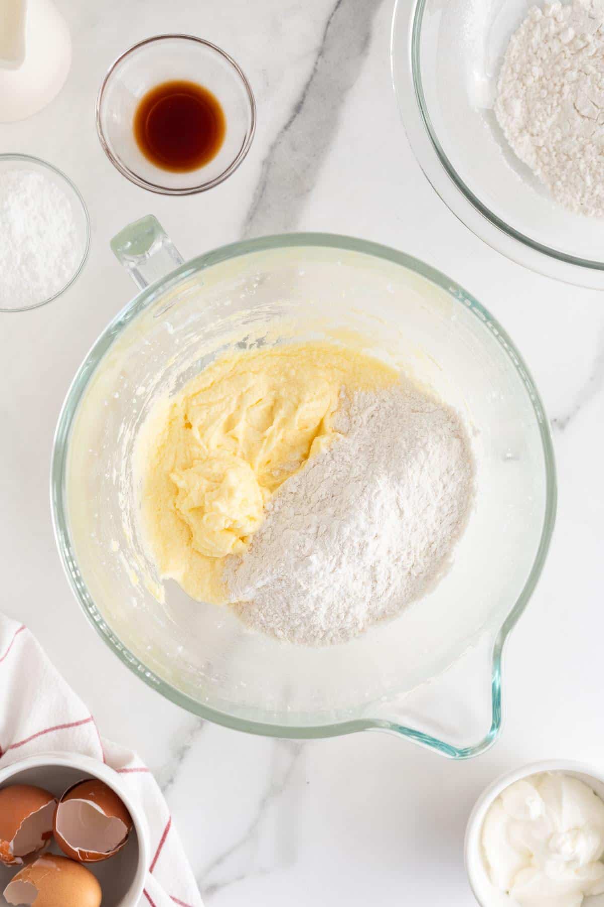 Flour being combined with the wet mixture in the bowl